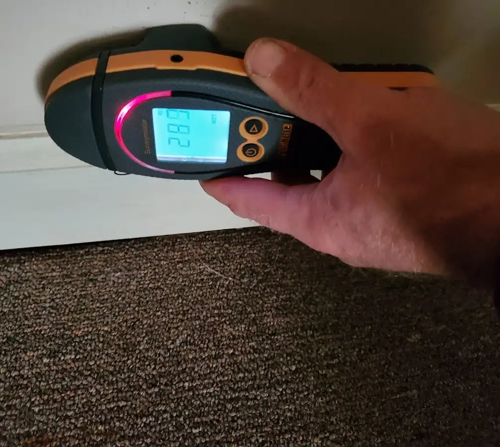 Moisture detection at baseboard during Storm Damage Restoration in North Tustin
